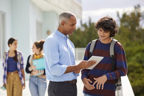 adult professional with student reviewing a letter